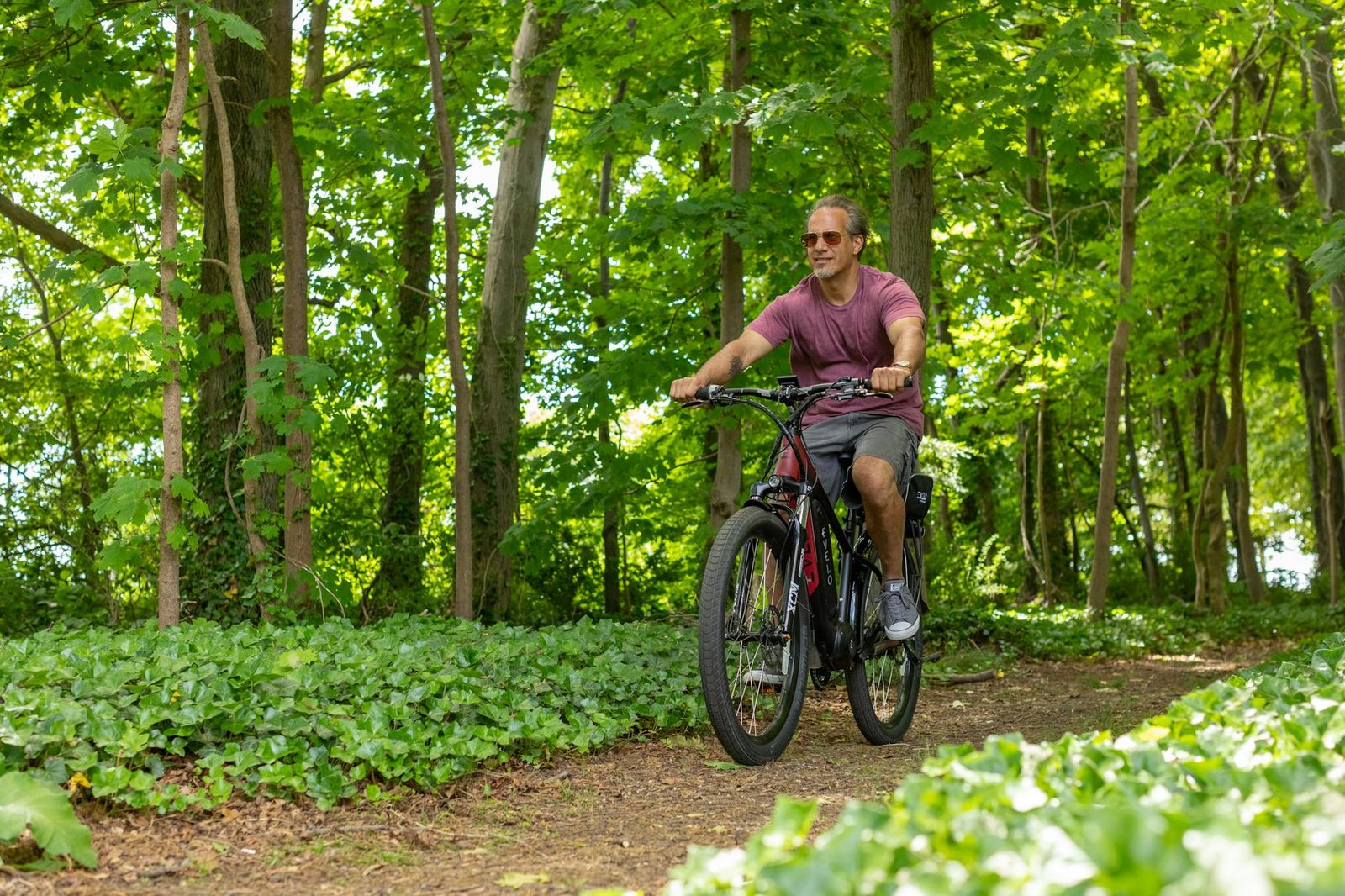 a man riding a bike through a forest